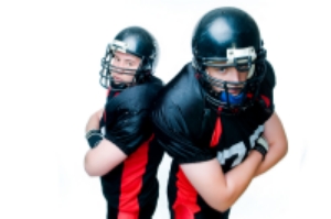 Two football players with arms crossed