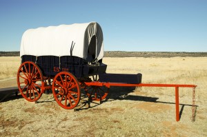 Black covered wagon with red wheels